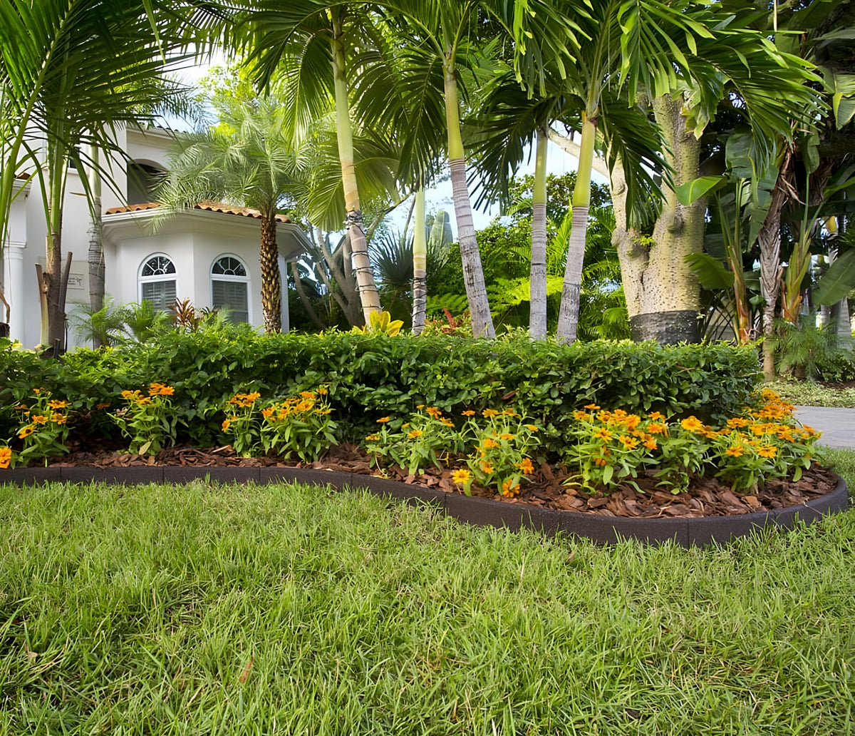 Brown EcoBorder L edging around a flower bed in front of a home